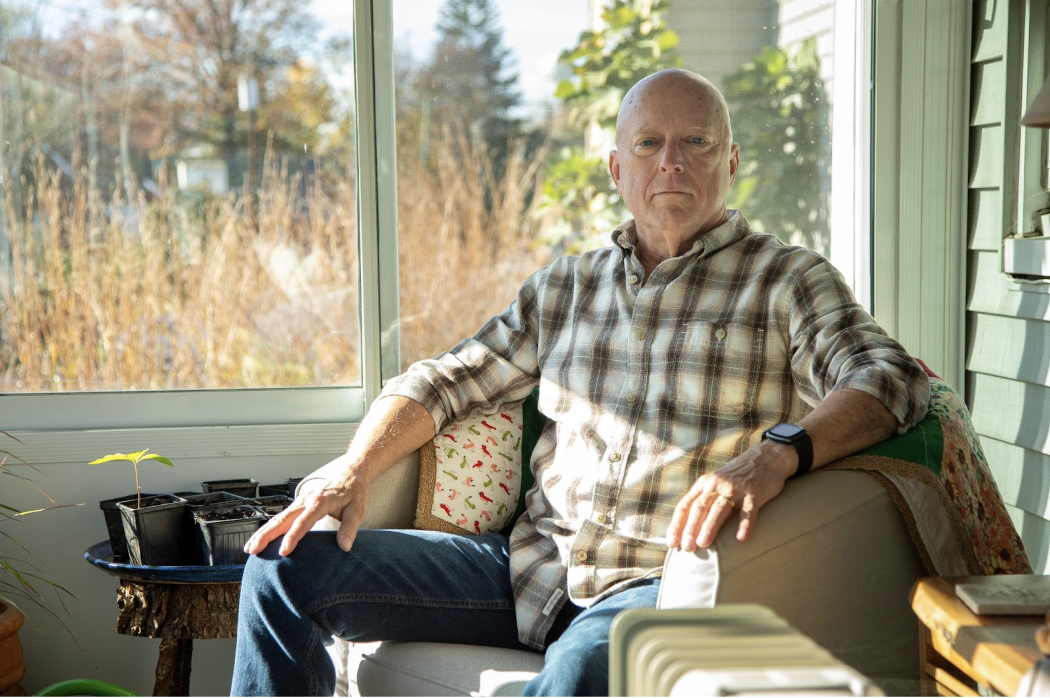 Chuck Keller sits on his sunny porch in Fort Thomas, Kentucky.